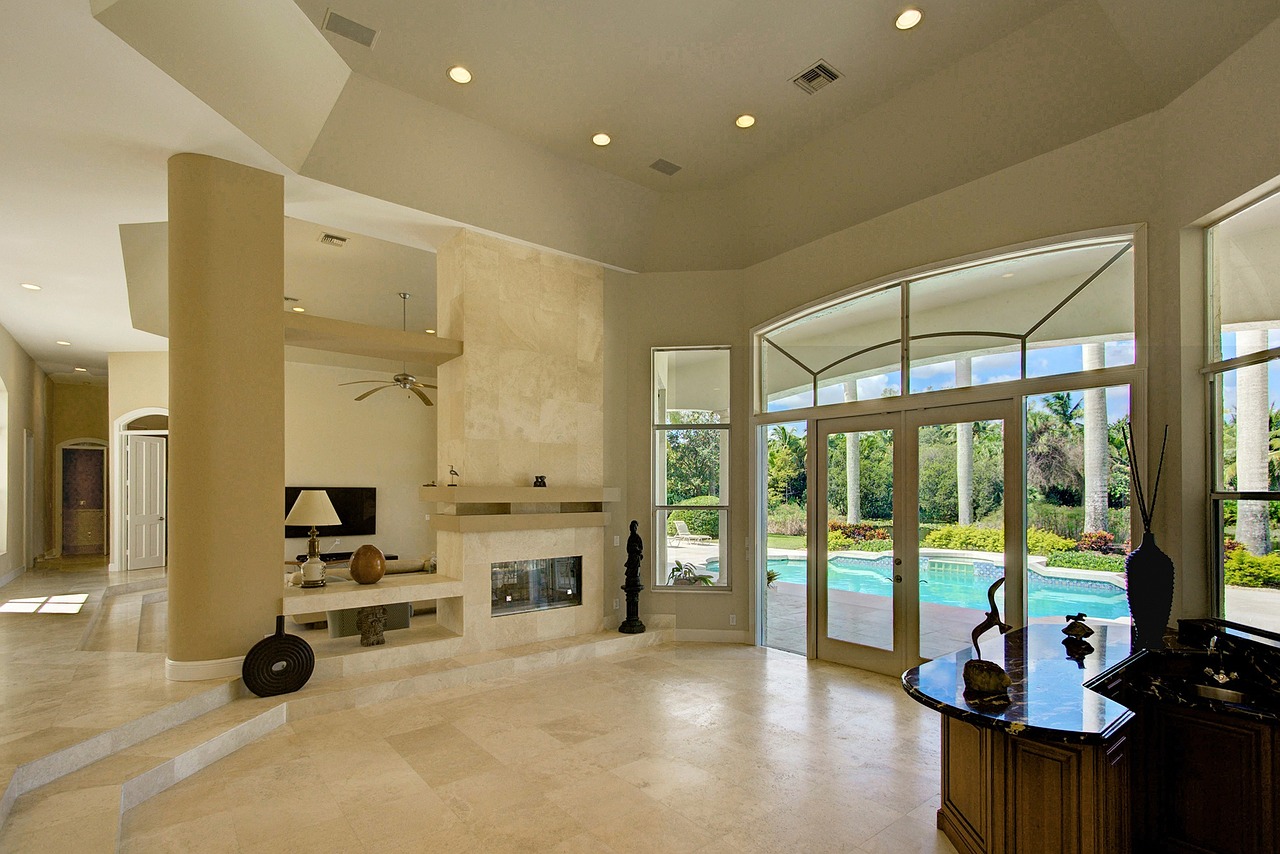 Large white living room with high ceilings and marble flooring